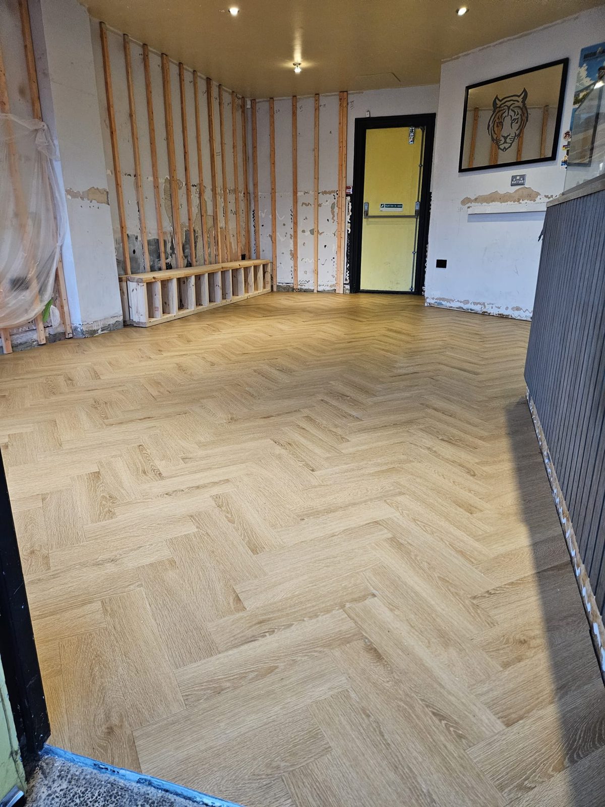 Finished herringbone LVT running the length of the café seating area